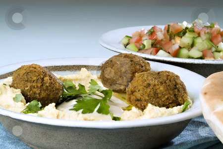To use this stock image in your creative project, please select the size you need over to the right and click the "Add to Cart" button.
Your downloaded image will come with the Cutcaster watermark removed so don’t worry about the watermark you see on this page. Hummus falafel and arabic salad stock photo, Falafel balls with hummus, arabic salad, pita and a tahini sauce. by Noam Armonn