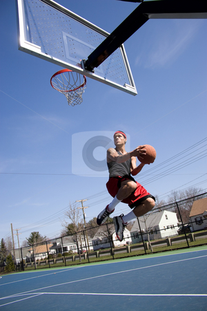 To use this stock image in your creative project, please select the size you need over to the right and click the "Add to Cart" button.
Your downloaded image will come with the Cutcaster watermark removed so don’t worry about the watermark you see on this page. Man Playing Basketball stock photo, A young basketball player driving to the hoop with some fancy moves. by Todd Arena