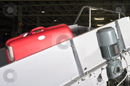 To use this stock image in your creative project, please select the size you need over to the right and click the "Add to Cart" button.
Your downloaded image will come with the Cutcaster watermark removed so don’t worry about the watermark you see on this page. Luggage conveyor belt stock photo, A red suitcase on an airport conveyor belt being transported to an airplane by Corepics VOF