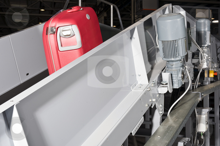 To use this stock image in your creative project, please select the size you need over to the right and click the "Add to Cart" button.
Your downloaded image will come with the Cutcaster watermark removed so don’t worry about the watermark you see on this page. Luggage conveyor belt stock photo, A red suitcase on an airport conveyor belt being transported to an airplane by Corepics VOF
