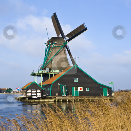To use this stock image in your creative project, please select the size you need over to the right and click the "Add to Cart" button.
Your downloaded image will come with the Cutcaster watermark removed so don’t worry about the watermark you see on this page. Dutch Windmill stock photo, A typical Dutch Windmill in de Zaanse Schans by Corepics VOF