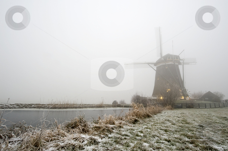 To use this stock image in your creative project, please select the size you need over to the right and click the "Add to Cart" button.
Your downloaded image will come with the Cutcaster watermark removed so don’t worry about the watermark you see on this page. Windmill on a foggy winter morning stock photo, A typical Dutch windmill on a foggy winter morning with ice covered canals, and a frozen dyke by Corepics VOF