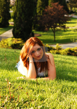 To use this stock image in your creative project, please select the size you need over to the right and click the "Add to Cart" button.
Your downloaded image will come with the Cutcaster watermark removed so don’t worry about the watermark you see on this page. Red haired beauty. stock photo, Beautiful red haired girl lying on the grass in an park and enjoying the
gorgeous sunset. by Horst Petzold