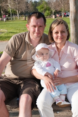 To use this stock image in your creative project, please select the size you need over to the right and click the "Add to Cart" button.
Your downloaded image will come with the Cutcaster watermark removed so don’t worry about the watermark you see on this page. Family portrait stock photo, Portrait of happy familly sitting on a bench in a park. by Mariusz Jurgielewicz