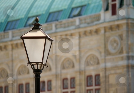 To use this stock image in your creative project, please select the size you need over to the right and click the "Add to Cart" button.
Your downloaded image will come with the Cutcaster watermark removed so don’t worry about the watermark you see on this page. Lamp and facade stock photo, White black lamp with a historical facade in background by Juraj Kovacik