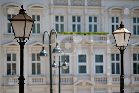 To use this stock image in your creative project, please select the size you need over to the right and click the "Add to Cart" button.
Your downloaded image will come with the Cutcaster watermark removed so don’t worry about the watermark you see on this page. Lamps stock photo, Lamps with facade of historical building in background by Juraj Kovacik
