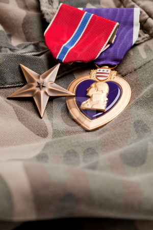To use this stock image in your creative project, please select the size you need over to the right and click the "Add to Cart" button.
Your downloaded image will come with the Cutcaster watermark removed so don’t worry about the watermark you see on this page. Bronze and Purple Heart Medals on Camouflage Material stock photo, Bronze and Purple Heart Medals on Camouflage Material by Andy Dean