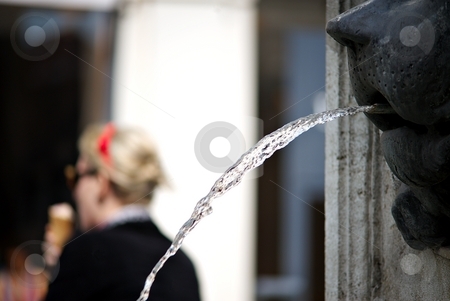 To use this stock image in your creative project, please select the size you need over to the right and click the "Add to Cart" button.
Your downloaded image will come with the Cutcaster watermark removed so don’t worry about the watermark you see on this page. Fountain in summer stock photo, Detail of a fountain with a woman with ice cream by Juraj Kovacik