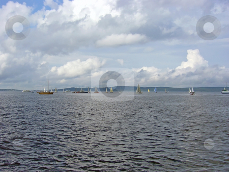 To use this stock image in your creative project, please select the size you need over to the right and click the "Add to Cart" button.
Your downloaded image will come with the Cutcaster watermark removed so don’t worry about the watermark you see on this page. Sea with yachts stock photo, Yachts against the coastline with the clouds by Sergej Razvodovskij