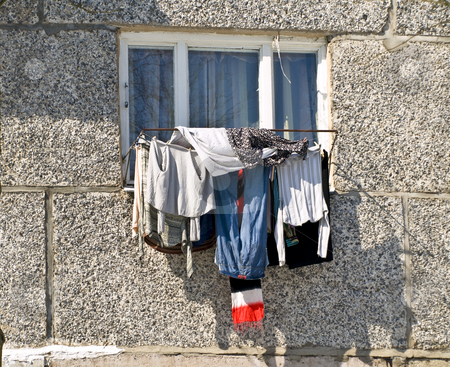 To use this stock image in your creative project, please select the size you need over to the right and click the "Add to Cart" button.
Your downloaded image will come with the Cutcaster watermark removed so don’t worry about the watermark you see on this page. Laundry stock photo, Unusual clean clothing dry against the home window by Sergej Razvodovskij