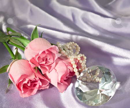 To use this stock image in your creative project, please select the size you need over to the right and click the "Add to Cart" button.
Your downloaded image will come with the Cutcaster watermark removed so don’t worry about the watermark you see on this page. Rosebuds and diamond and pearls stock photo, Three pink rosebuds with pearls and a diamond lying on lilac satin by Norma Cornes