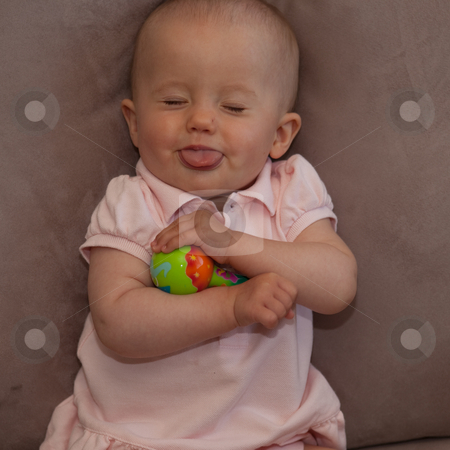 To use this stock image in your creative project, please select the size you need over to the right and click the "Add to Cart" button.
Your downloaded image will come with the Cutcaster watermark removed so don’t worry about the watermark you see on this page. Playing on a sofa stock photo, Little caucasian baby girl sitting on a sofa. by Mariusz Jurgielewicz