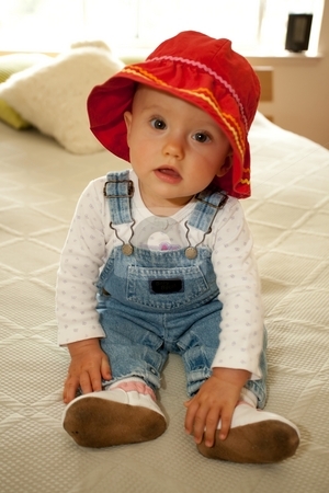 To use this stock image in your creative project, please select the size you need over to the right and click the "Add to Cart" button.
Your downloaded image will come with the Cutcaster watermark removed so don’t worry about the watermark you see on this page. Red Hat stock photo, Cute little caucasian baby girl wearing red hat and sitting on a bed. by Mariusz Jurgielewicz