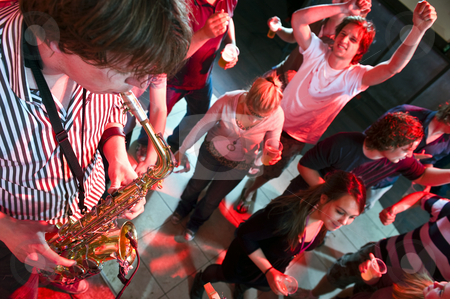 To use this stock image in your creative project, please select the size you need over to the right and click the "Add to Cart" button.
Your downloaded image will come with the Cutcaster watermark removed so don’t worry about the watermark you see on this page. Saxophonist stock photo, Saxophonist playing in a nightclub, with dancing people in the background by Corepics VOF