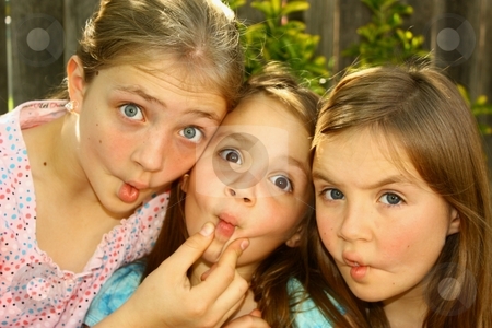 To use this stock image in your creative project, please select the size you need over to the right and click the "Add to Cart" button.
Your downloaded image will come with the Cutcaster watermark removed so don’t worry about the watermark you see on this page. 3 fish lips stock photo, Three cute girls doing fish lips by Gregory Dean