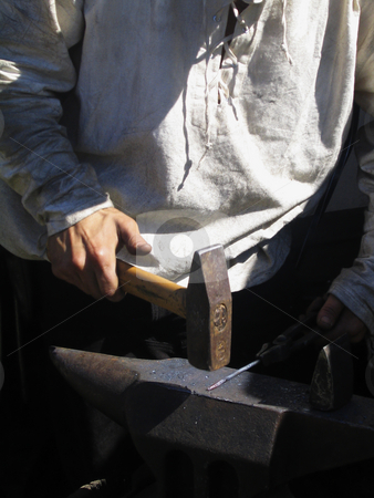 To use this stock image in your creative project, please select the size you need over to the right and click the "Add to Cart" button.
Your downloaded image will come with the Cutcaster watermark removed so don’t worry about the watermark you see on this page. Blacksmith working stock photo, A young blacksmith in white shirt forging a nail by Alessandro Rizzolli