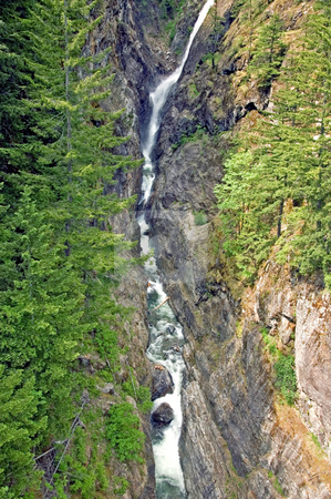 To use this stock image in your creative project, please select the size you need over to the right and click the "Add to Cart" button.
Your downloaded image will come with the Cutcaster watermark removed so don’t worry about the watermark you see on this page. Long Steep Waterfall stock photo, This narrow but long waterfall is through steep crags in the mountain in this stunning landscape scene. by Valerie Garner