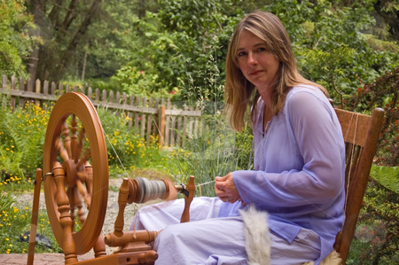 To use this stock image in your creative project, please select the size you need over to the right and click the "Add to Cart" button.
Your downloaded image will come with the Cutcaster watermark removed so don’t worry about the watermark you see on this page. Woman Spinning Yarn stock photo, This Caucasian woman is spinning wool on a spinning wheel into homespun crafted yarn as an artisan in action. by Valerie Garner