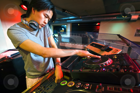 To use this stock image in your creative project, please select the size you need over to the right and click the "Add to Cart" button.
Your downloaded image will come with the Cutcaster watermark removed so don’t worry about the watermark you see on this page. DJ in the Mix stock photo, DJ working on the faders and turntables during his act in a club by Corepics VOF