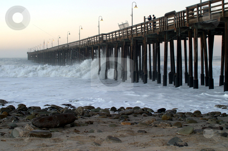 To use this stock image in your creative project, please select the size you need over to the right and click the "Add to Cart" button.
Your downloaded image will come with the Cutcaster watermark removed so don’t worry about the watermark you see on this page. Ocean Wave Storm Pier stock photo, Ocean waves throughout at storm crashing into a wooden pier. by Henrik Lehnerer