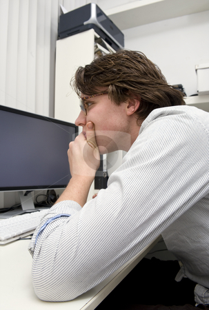 To use this stock image in your creative project, please select the size you need over to the right and click the "Add to Cart" button.
Your downloaded image will come with the Cutcaster watermark removed so don’t worry about the watermark you see on this page. Concentration at work stock photo, A designer staring in deep concentratio at his computer screens, elbow on the table, chin resting in his hand by Corepics VOF