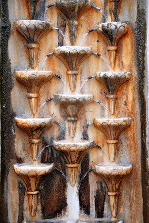 To use this stock image in your creative project, please select the size you need over to the right and click the "Add to Cart" button.
Your downloaded image will come with the Cutcaster watermark removed so don’t worry about the watermark you see on this page. Wall fountain stock photo, Old stone wall rusty fountain texture outdoor by Julija Sapic