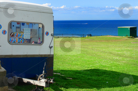 To use this stock image in your creative project, please select the size you need over to the right and click the "Add to Cart" button.
Your downloaded image will come with the Cutcaster watermark removed so don’t worry about the watermark you see on this page. Ice cream van stock photo, Greem grass field, cloudy blue sky ocean and Ice cream van. by Marc Torrell