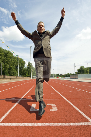 To use this stock image in your creative project, please select the size you need over to the right and click the "Add to Cart" button.
Your downloaded image will come with the Cutcaster watermark removed so don’t worry about the watermark you see on this page. Success in Business stock photo, Metaphore for success in business - a business man crossing the finish line on an athletics track with his arms raised in victory by Corepics VOF