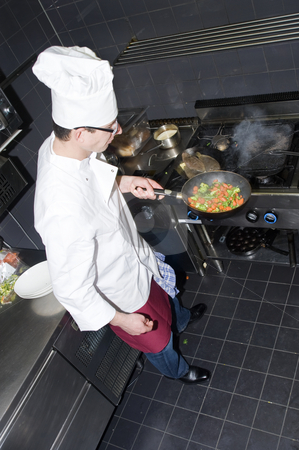 To use this stock image in your creative project, please select the size you need over to the right and click the "Add to Cart" button.
Your downloaded image will come with the Cutcaster watermark removed so don’t worry about the watermark you see on this page. Chef and Sous-chef stock photo, A chef and his sous-chef working in a kitchen by Corepics VOF