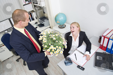 To use this stock image in your creative project, please select the size you need over to the right and click the "Add to Cart" button.
Your downloaded image will come with the Cutcaster watermark removed so don’t worry about the watermark you see on this page. Business gift stock photo, Senior manager giving his younger female associate a large flower pot with white daisies by Corepics VOF