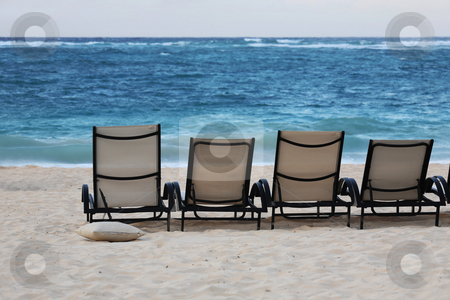 To use this stock image in your creative project, please select the size you need over to the right and click the "Add to Cart" button.
Your downloaded image will come with the Cutcaster watermark removed so don’t worry about the watermark you see on this page. Lounge chairs on beach stock photo, Lounge chairs on beach of Punta Cana, Dominican Republic by Tom P.