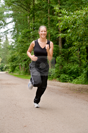 To use this stock image in your creative project, please select the size you need over to the right and click the "Add to Cart" button.
Your downloaded image will come with the Cutcaster watermark removed so don’t worry about the watermark you see on this page. Sportive young woman running over a forrest road stock photo, Young adult jogging on a forest road by Frenk and Danielle Kaufmann