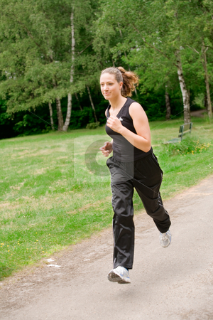 To use this stock image in your creative project, please select the size you need over to the right and click the "Add to Cart" button.
Your downloaded image will come with the Cutcaster watermark removed so don’t worry about the watermark you see on this page. Sportive young woman running over a forrest road stock photo, Young adult jogging on a forest road by Frenk and Danielle Kaufmann