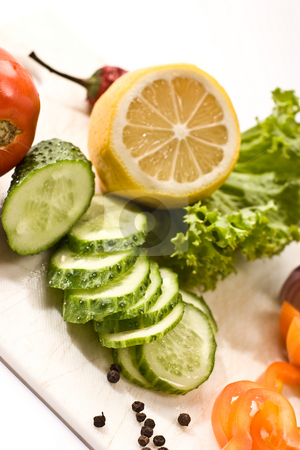 To use this stock image in your creative project, please select the size you need over to the right and click the "Add to Cart" button.
Your downloaded image will come with the Cutcaster watermark removed so don’t worry about the watermark you see on this page. Vegetarian diet stock photo, Vegetable mix: lettuce, onion, lemon, cucumber on the board by Gennady Kravetsky