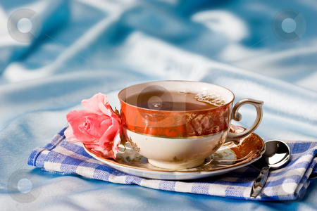 To use this stock image in your creative project, please select the size you need over to the right and click the "Add to Cart" button.
Your downloaded image will come with the Cutcaster watermark removed so don’t worry about the watermark you see on this page. Cup of tea stock photo, Cup of tea with flower over azure by Gennady Kravetsky