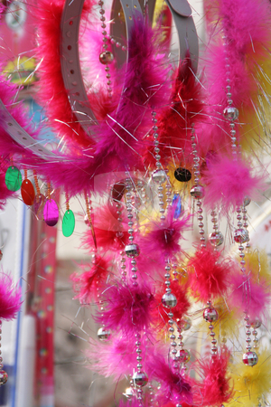 To use this stock image in your creative project, please select the size you need over to the right and click the "Add to Cart" button.
Your downloaded image will come with the Cutcaster watermark removed so don’t worry about the watermark you see on this page. Beads Bangles and Feathers Chinese New Year Head Gear stock photo, Feathers, beads and bangles head bands for Chinese Lunar New Year sold at temple fair in Beijing China by William Perry