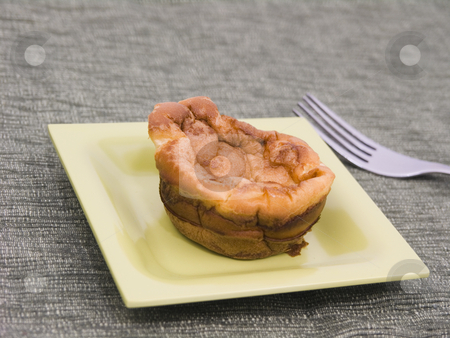 To use this stock image in your creative project, please select the size you need over to the right and click the "Add to Cart" button.
Your downloaded image will come with the Cutcaster watermark removed so don’t worry about the watermark you see on this page. Yorkshire Pudding stock photo, Yorkshire pudding on a green plate with fork by John Teeter