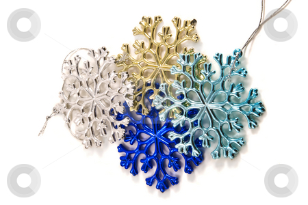 To use this stock image in your creative project, please select the size you need over to the right and click the "Add to Cart" button.
Your downloaded image will come with the Cutcaster watermark removed so don’t worry about the watermark you see on this page. Christmas Snowflake Decoroations stock photo, Multicolored snowflake shaped christmas decorations by Steve Carroll
