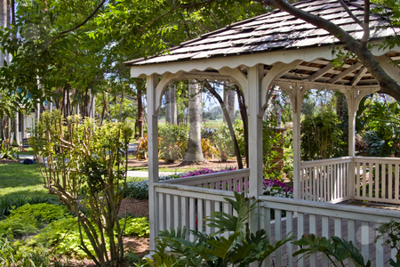 To use this stock image in your creative project, please select the size you need over to the right and click the "Add to Cart" button.
Your downloaded image will come with the Cutcaster watermark removed so don’t worry about the watermark you see on this page. Gazebo in Tropical Garden stock photo, White gazebo in lush, tropical garden. by Steve Carroll