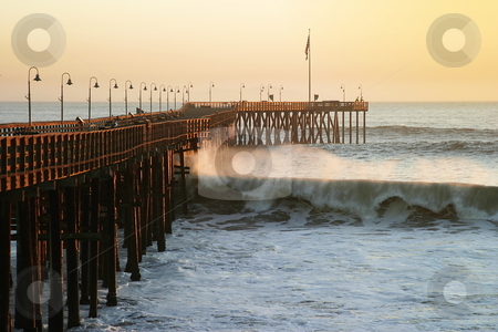 To use this stock image in your creative project, please select the size you need over to the right and click the "Add to Cart" button.
Your downloaded image will come with the Cutcaster watermark removed so don’t worry about the watermark you see on this page. Ocean Wave Storm Pier stock photo, Ocean waves throughout at storm crashing into a wooden pier. by Henrik Lehnerer