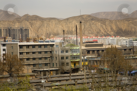 To use this stock image in your creative project, please select the size you need over to the right and click the "Add to Cart" button.
Your downloaded image will come with the Cutcaster watermark removed so don’t worry about the watermark you see on this page. Chinese Factory with Chimneys Apartments Gansu Province, Qinghai stock photo, Chinese factory and chimneys apartments in front of mountains, Lanzhou City, Gansu Province, China by William Perry