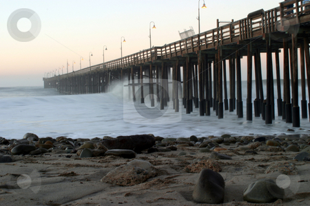 To use this stock image in your creative project, please select the size you need over to the right and click the "Add to Cart" button.
Your downloaded image will come with the Cutcaster watermark removed so don’t worry about the watermark you see on this page. Ocean Wave Storm Pier stock photo, Ocean waves throughout at storm crashing into a wooden pier. by Henrik Lehnerer