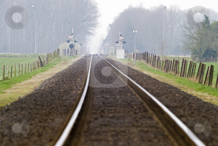 To use this stock image in your creative project, please select the size you need over to the right and click the "Add to Cart" button.
Your downloaded image will come with the Cutcaster watermark removed so don’t worry about the watermark you see on this page. Railtrack with hazy crossing. stock photo, Railtrack with hazy crossing in the background. by Gert-Jan Kappert