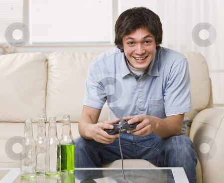 To use this stock image in your creative project, please select the size you need over to the right and click the "Add to Cart" button.
Your downloaded image will come with the Cutcaster watermark removed so don’t worry about the watermark you see on this page. Boy Playing Video Games stock photo, A teenage boy is sitting on his couch and playing video games. He is smiling at the camera. Horizontally framed shot. by Jonathan Ross