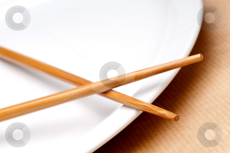 To use this stock image in your creative project, please select the size you need over to the right and click the "Add to Cart" button.
Your downloaded image will come with the Cutcaster watermark removed so don’t worry about the watermark you see on this page. A tilted horizontal macro of a pair of chopsticks on a white pla stock photo, A tilted horizontal macro of a pair of chopsticks on a white plate by Vince Clements