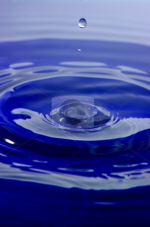 To use this stock image in your creative project, please select the size you need over to the right and click the "Add to Cart" button.
Your downloaded image will come with the Cutcaster watermark removed so don’t worry about the watermark you see on this page. Splash stock photo, A high speed shot of a droplet of water, before it hits the blue liquid surface. by Martin Darley