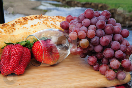 To use this stock image in your creative project, please select the size you need over to the right and click the "Add to Cart" button.
Your downloaded image will come with the Cutcaster watermark removed so don’t worry about the watermark you see on this page. Berries And Wine Glass stock photo, Fruit and and wine glass in a scenic mountain setting on a bright sunny day by Lynn Bendickson