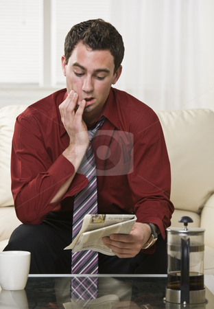 To use this stock image in your creative project, please select the size you need over to the right and click the "Add to Cart" button.
Your downloaded image will come with the Cutcaster watermark removed so don’t worry about the watermark you see on this page. Attractive male reading Newspaper stock photo, Attractive male reading the paper with a concerned and focused look on his face. Drinking coffee, looking at the paper. vertical. by Jonathan Ross