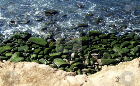 To use this stock image in your creative project, please select the size you need over to the right and click the "Add to Cart" button.
Your downloaded image will come with the Cutcaster watermark removed so don’t worry about the watermark you see on this page. Green mossy rocks along the coast stock photo, View of pacific coast with mossy rock and gentle surf by Jill Reid