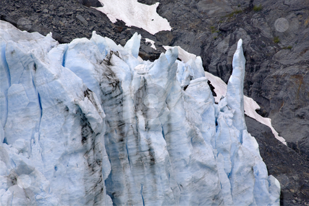 To use this stock image in your creative project, please select the size you need over to the right and click the "Add to Cart" button.
Your downloaded image will come with the Cutcaster watermark removed so don’t worry about the watermark you see on this page. Icy Blue Portage Glacier Crystalline Spike stock photo, Icy blue Portage Glacier spike Crystal with Rock, Anchorage, Alaska by William Perry